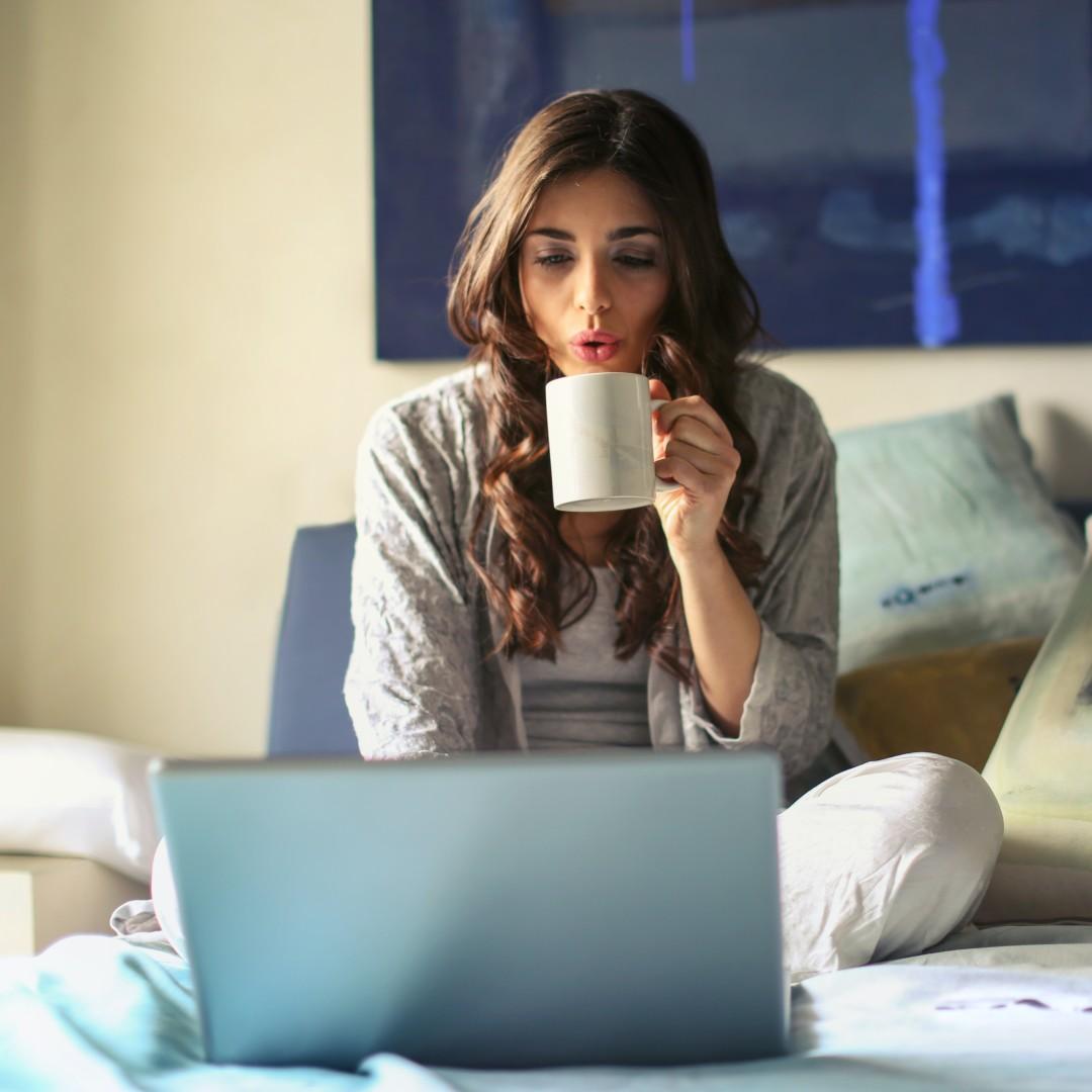 Girl drinking coffee at home in bed